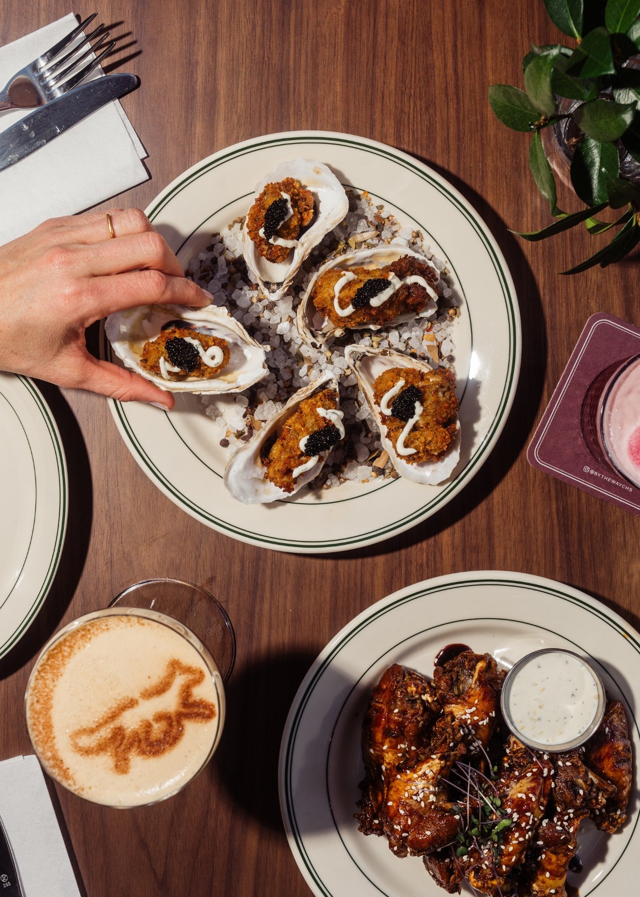 A plate of fried oyster and fox den wings at the bar at By The Way in Charleston