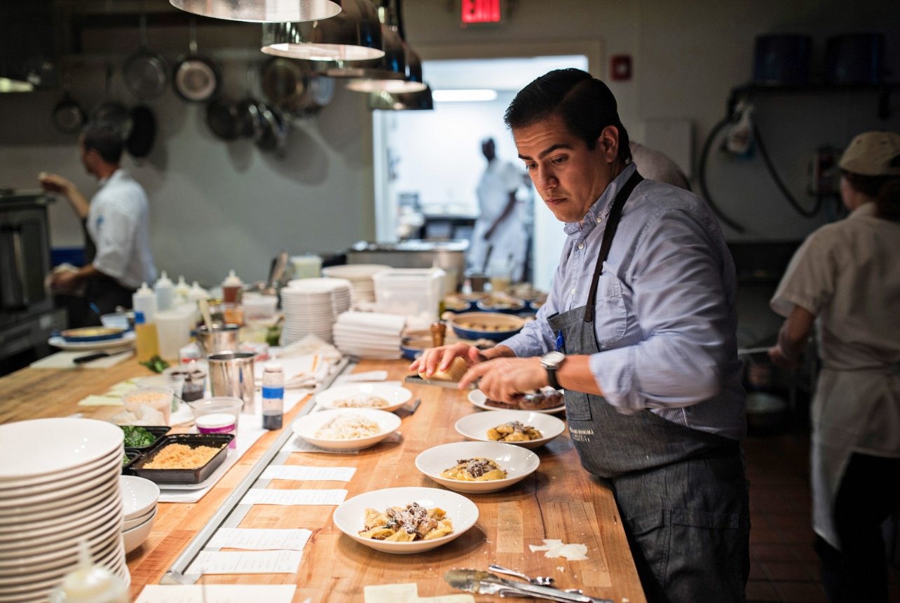 Chef Michael Toscano in kitchen at Le Farfelle preparing pasta dinners